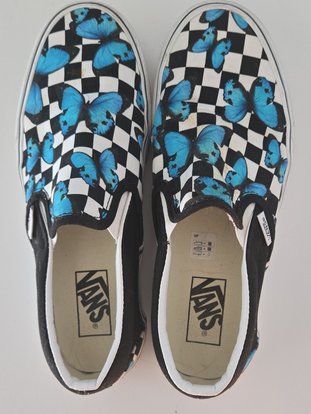 Vans Black & White Checkerboard Slip-Ons with Blue Butterfly Print - Picture 1 of 6